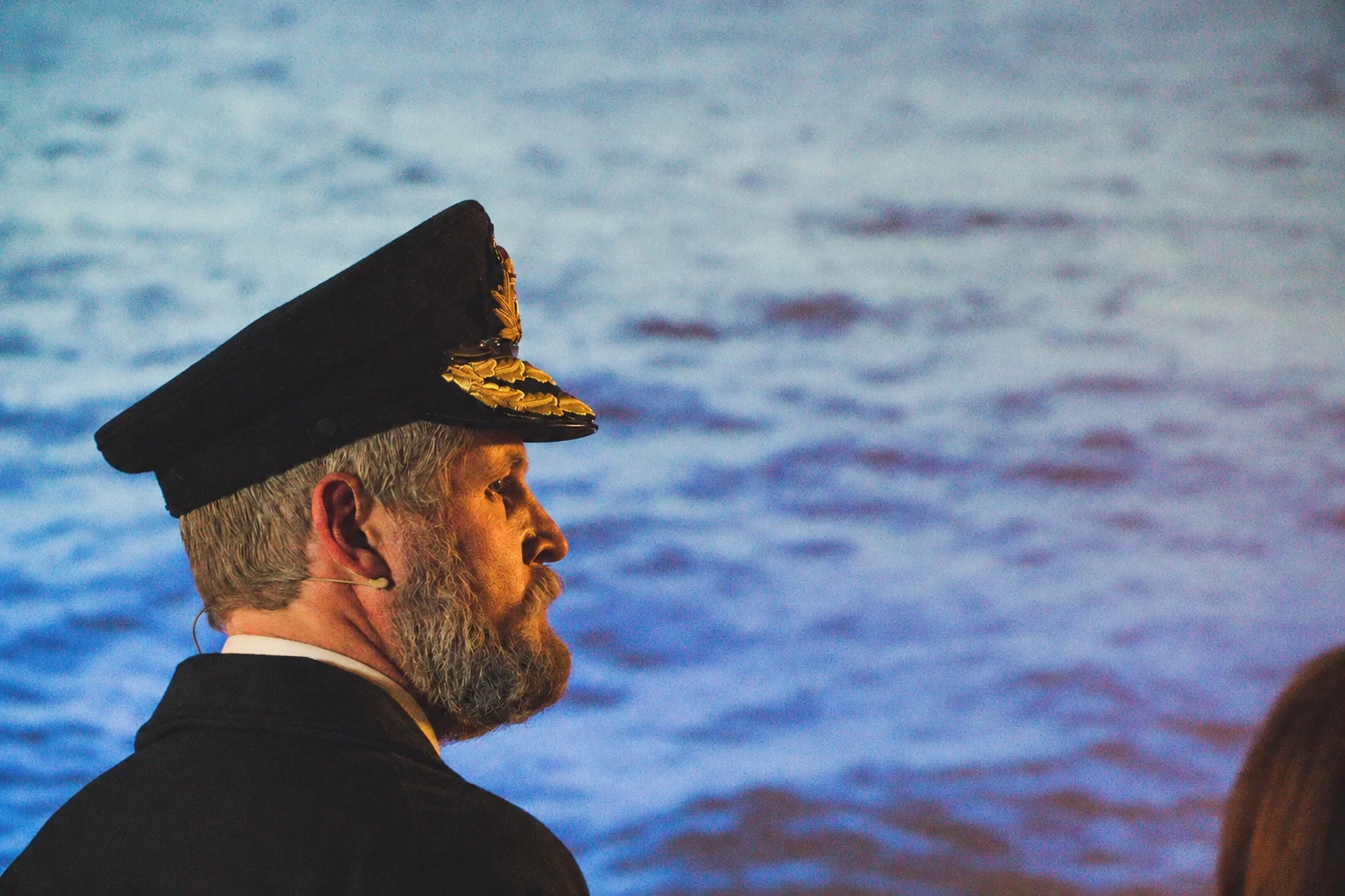 Captain Smith in uniform, with the ocean behind him