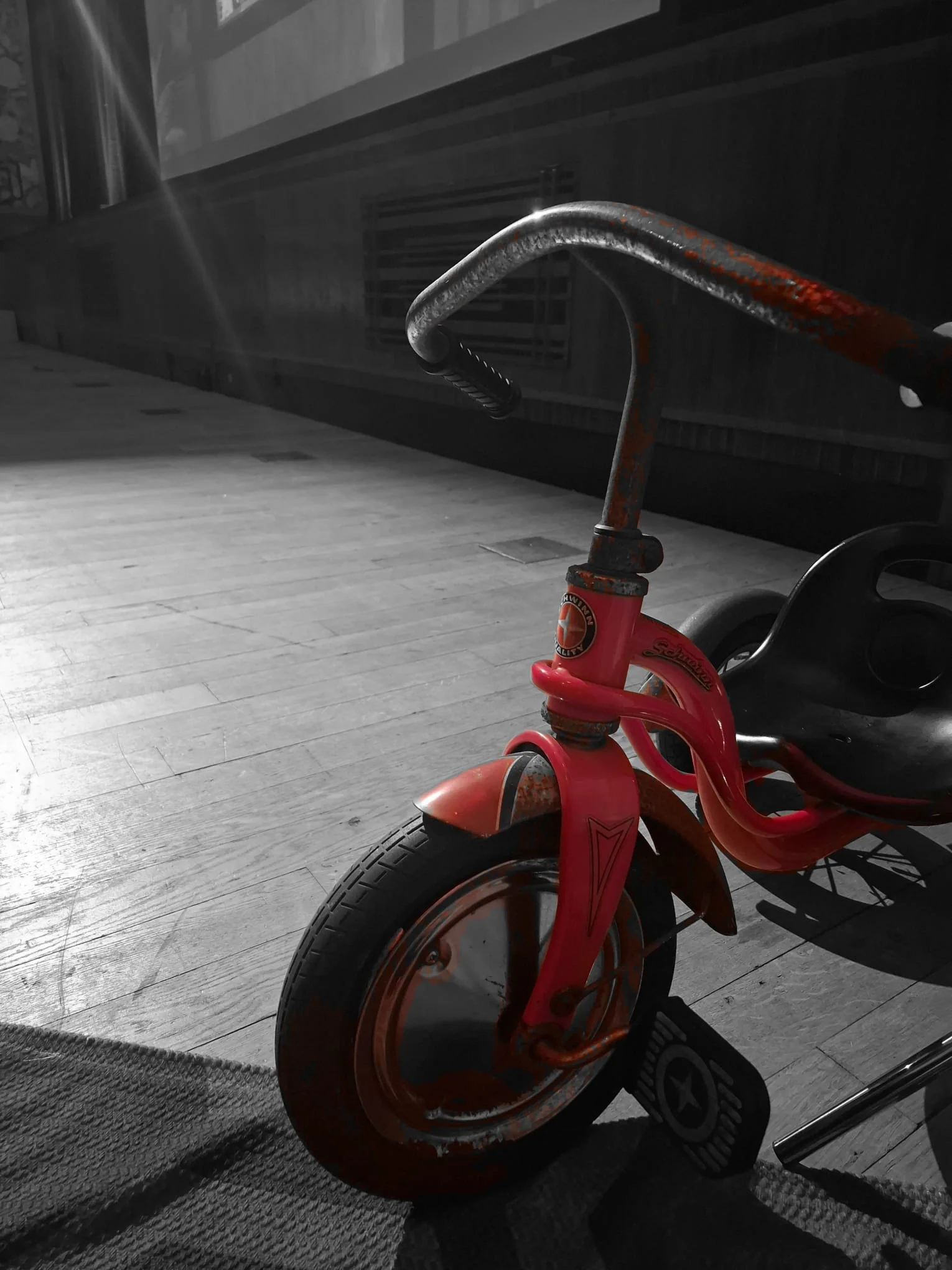 The red tricycle beneath the hotel staircase